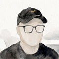 Watercolor portrait of Eric in a cap and glasses.